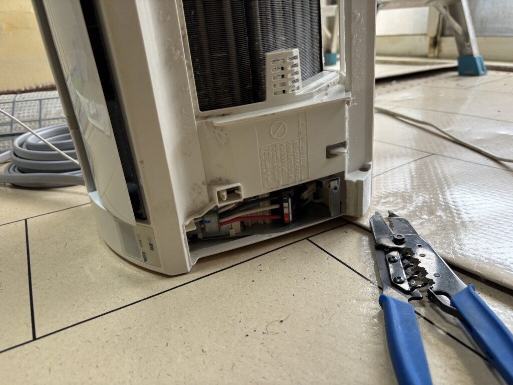 New electrical wiring and drain hose for air conditioner installation