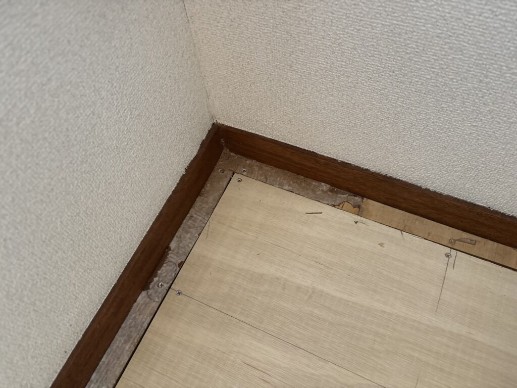 Joint between the existing and new plywood subfloor, prepared for floor leveling and cushion flooring installation.