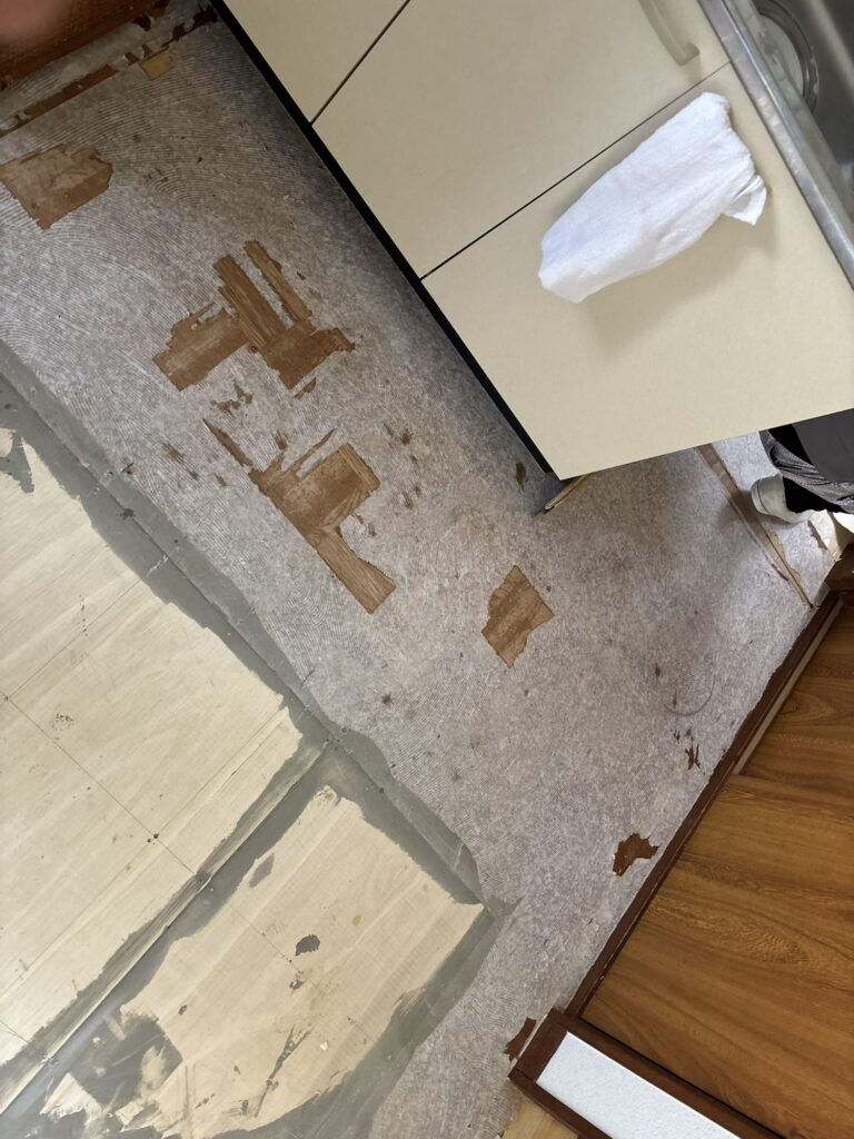 Moisture damaged plywood subfloor before vinyl flooring installation