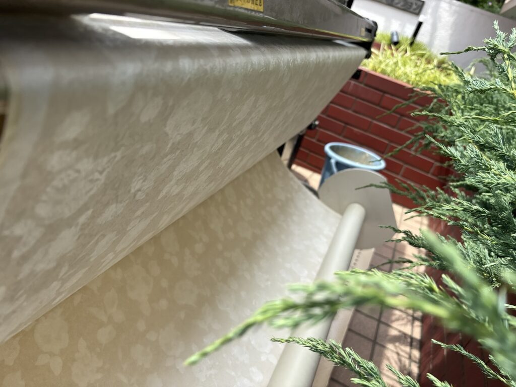 Patterned wallpaper with a repeating design that requires accurate pattern matching during installation.