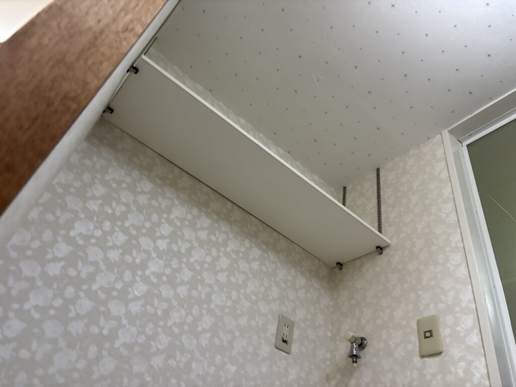 New wallpaper fully installed in the laundry room with clean seams and a smooth professional finish.