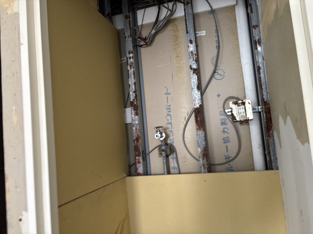 Installing new drywall panels in a residential laundry room.
