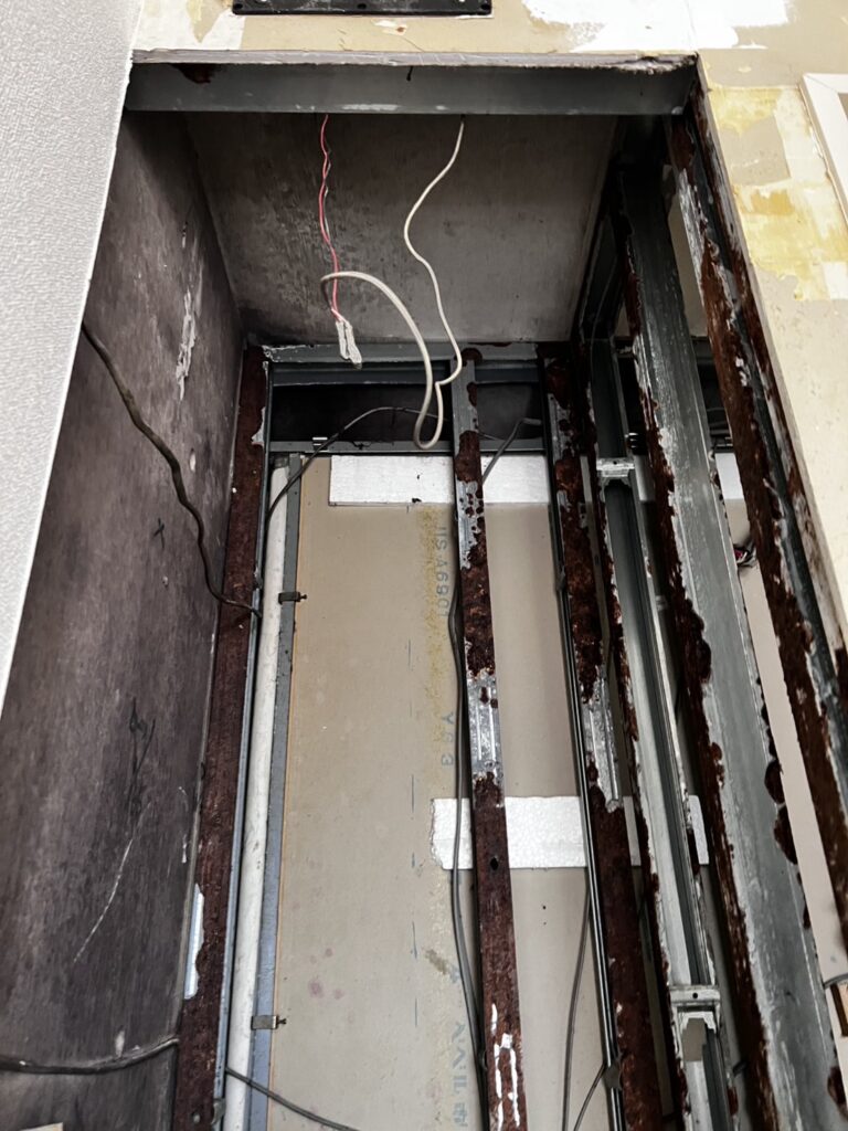 Demolition of water-damaged drywall in a residential laundry room.
