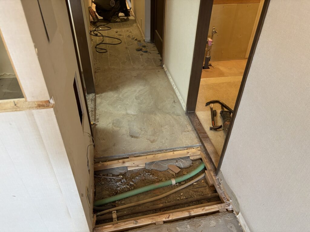 Concrete floor exposed after removing the old wooden subfloor in a Japanese condominium