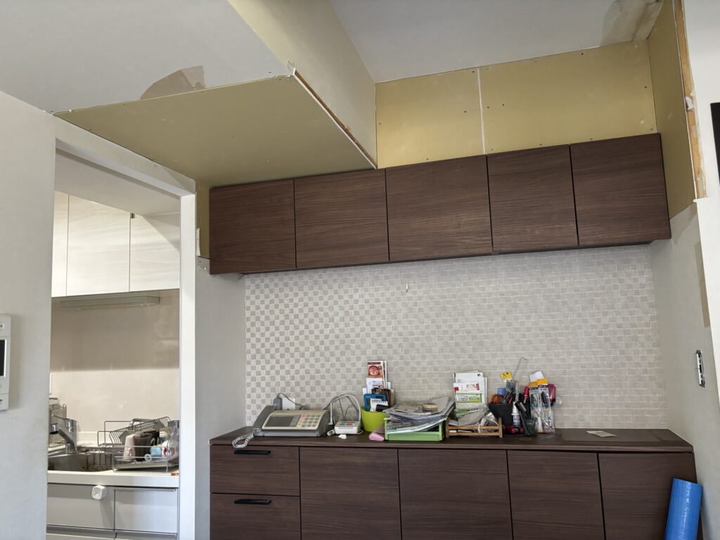 New drywall installed in a water-damaged area before wallpaper replacement.