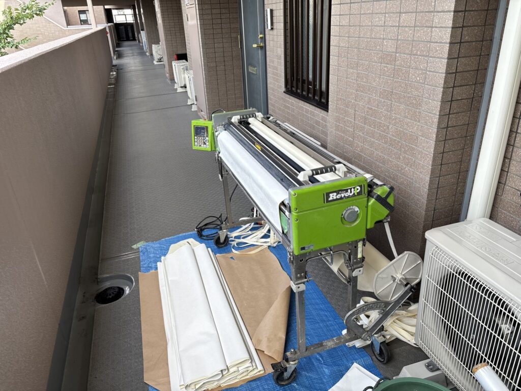 Professional wallpaper pasting machine used to prepare wallpaper for installation in a Japanese apartment.