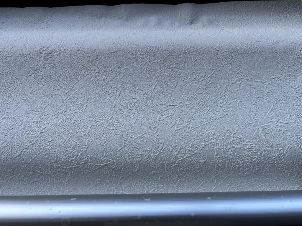 Rolls of stone-textured wallpaper prepared for installation in a Japanese condominium renovation.