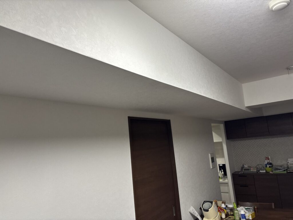 Completed wallpaper replacement in the living room of an occupied Japanese condominium.