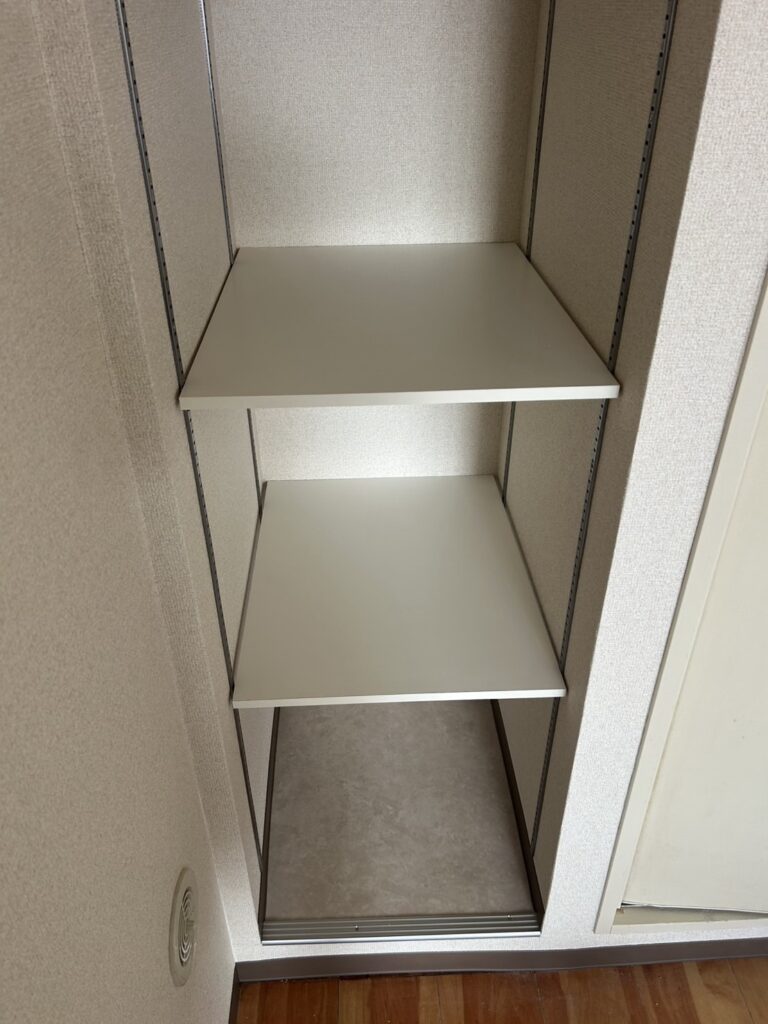 Finished laundry area and rebuilt storage shelf with new wallpaper and cushion flooring.
