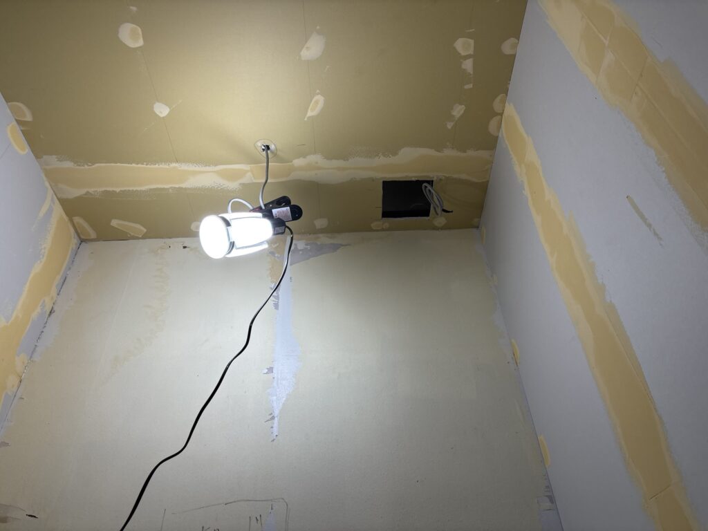 Wall with uneven finishing putty before sanding and wallpaper installation