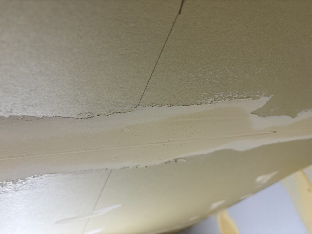 Raised and uneven putty on gypsum board before wallpaper installation