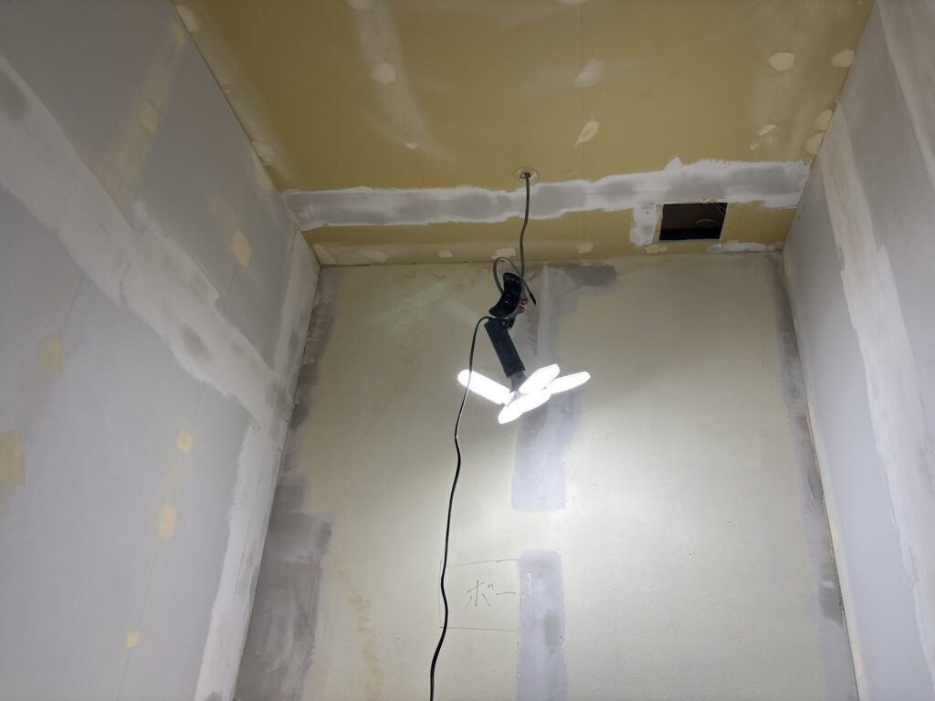Base putty reapplied to level an uneven gypsum board surface