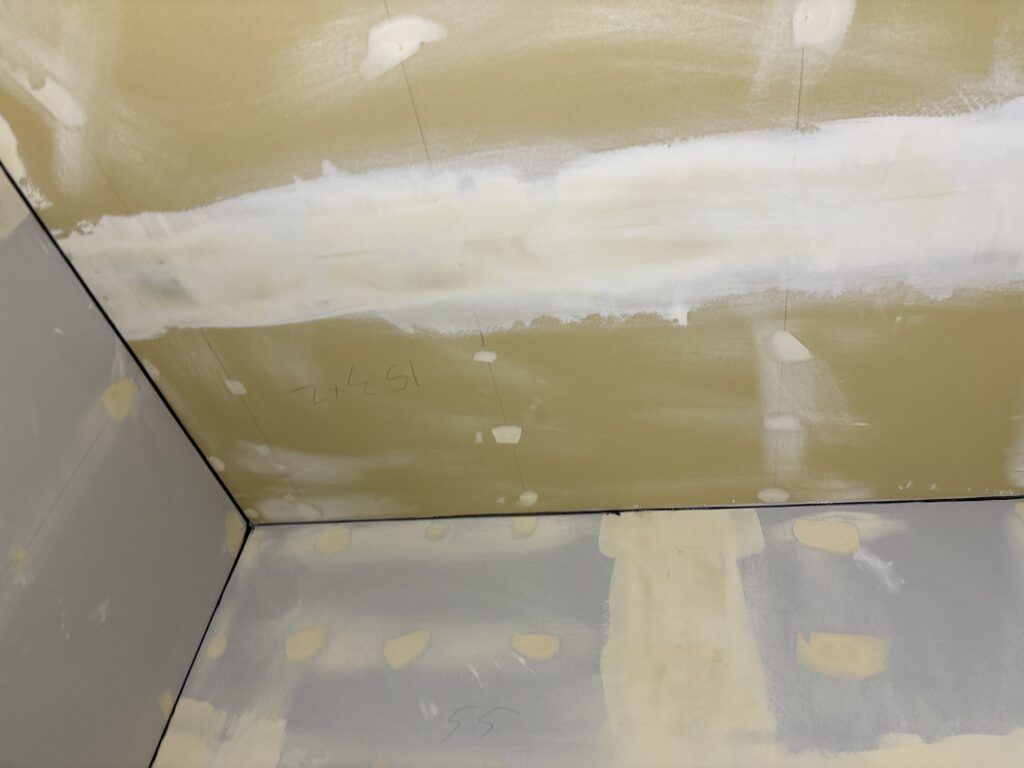 Wall surface after sanding dried finishing putty before wallpaper installation