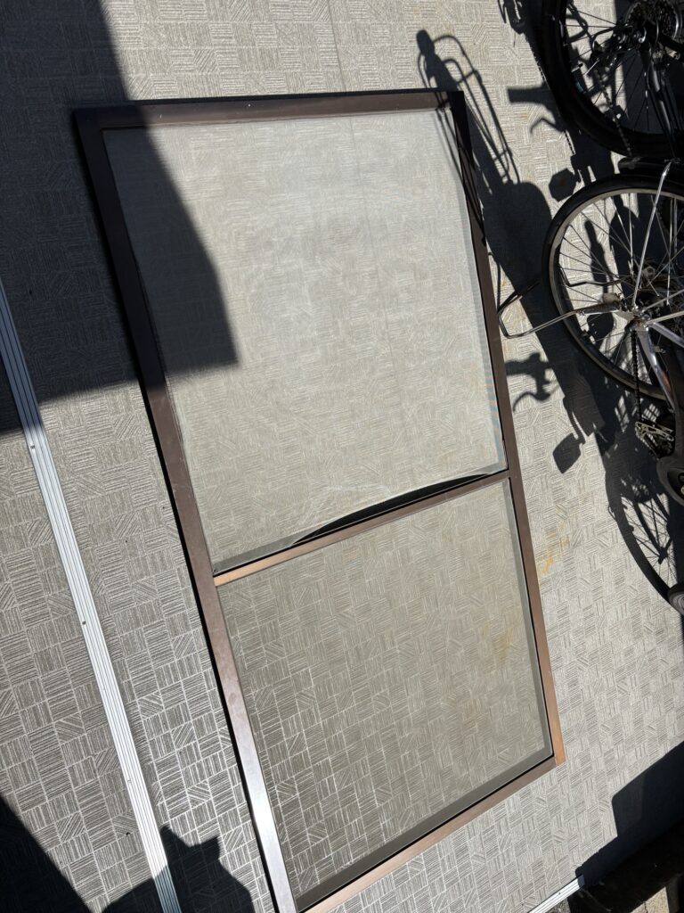 Japanese sliding screen door removed from the window frame for rescreening