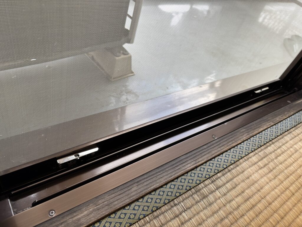 Japanese sliding screen door reinstalled after replacing the rollers and screen mesh