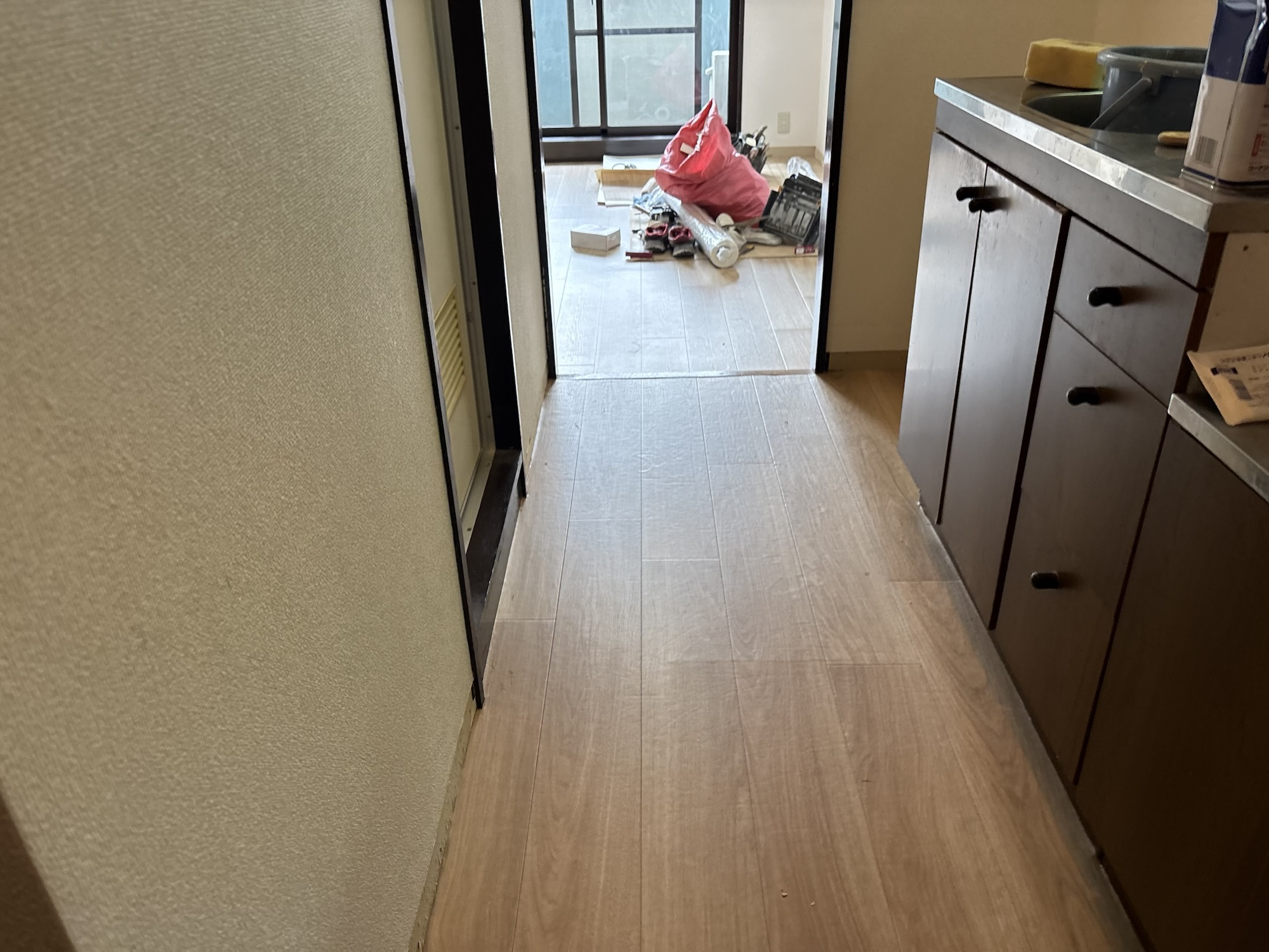 Finished cushion vinyl flooring installed in the kitchen of a Japanese apartment.