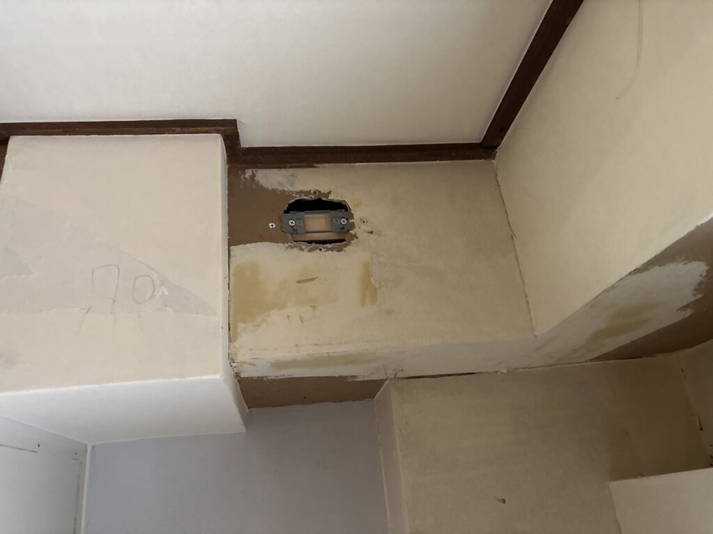 Beam with finishing compound applied before wallpaper installation in a Japanese apartment.