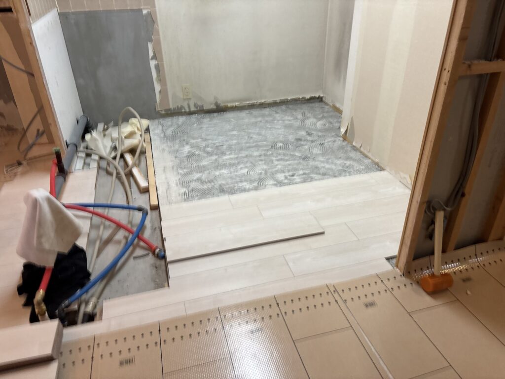 Wood flooring being installed in the kitchen of a Japanese condominium apartment.