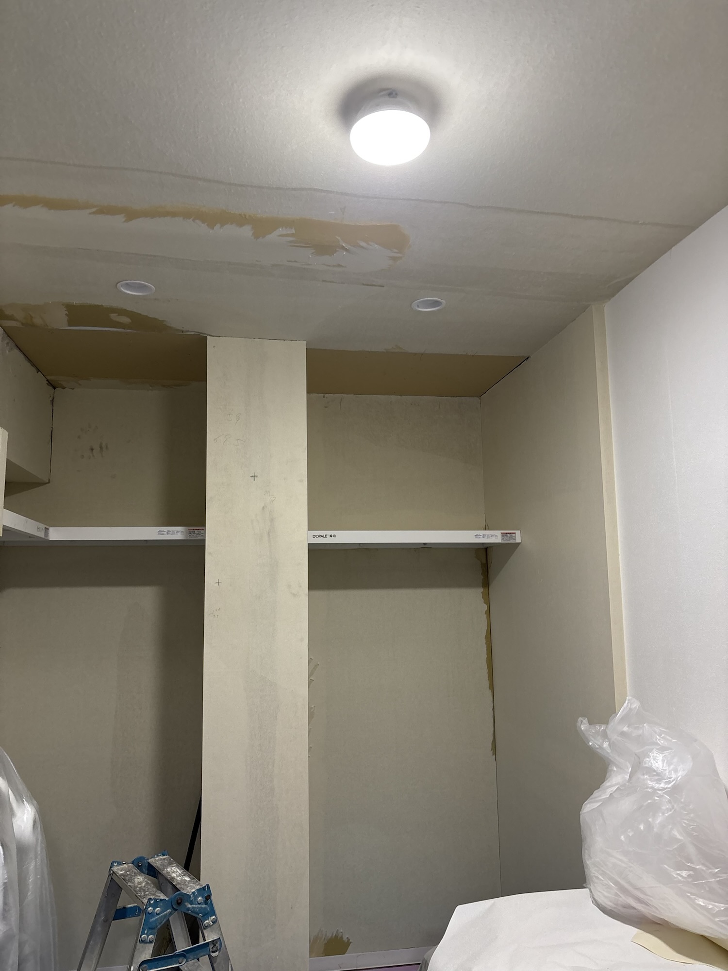 Full view of the ceiling after removing the old wallpaper and replacing the damaged section with new gypsum board.