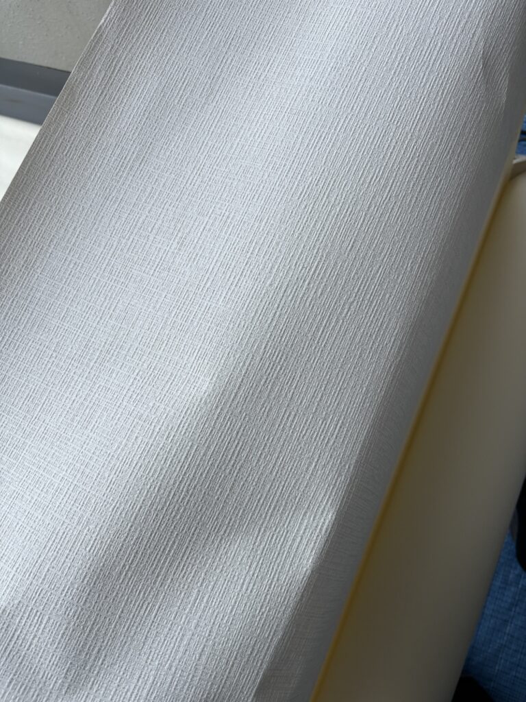 Close-up of thick embossed wallpaper material for a bathroom renovation.
