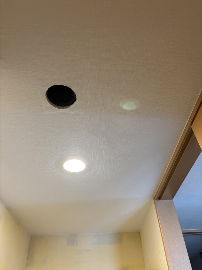 Completed embossed wallpaper installation on the bathroom ceiling.