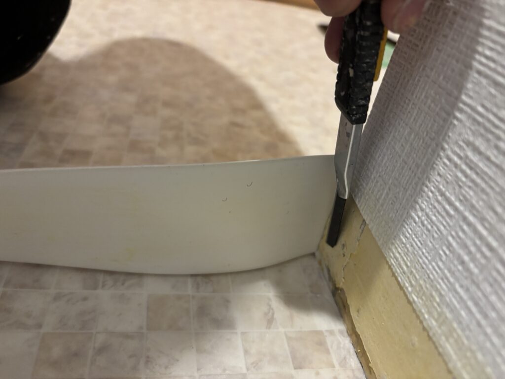 Small relief cut made on the back of a soft baseboard for an outside corner.