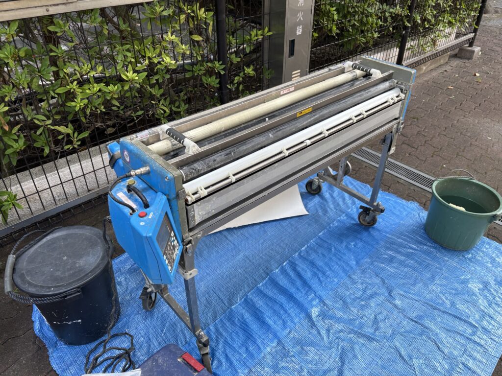 Wallpaper being prepared with a wallpaper pasting machine before installation