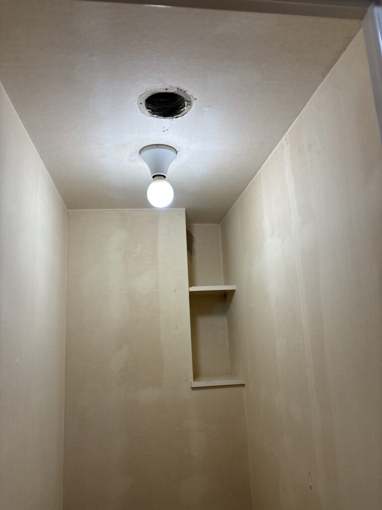 Toilet ceiling and walls after the old wallpaper has been removed