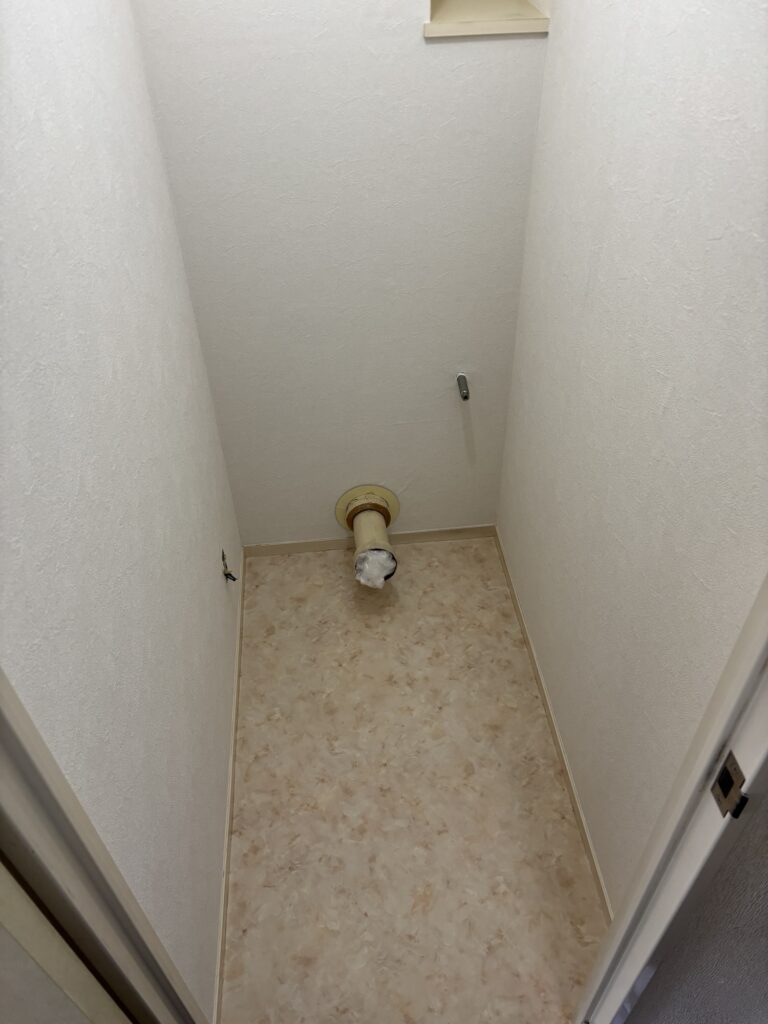 Completed toilet walls with new wallpaper and newly installed vinyl flooring