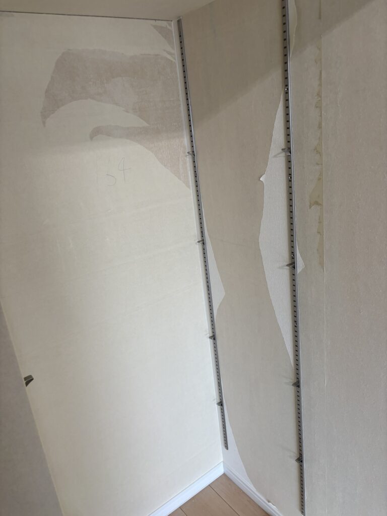 Walk-in closet before wallpaper replacement in a condominium apartment.