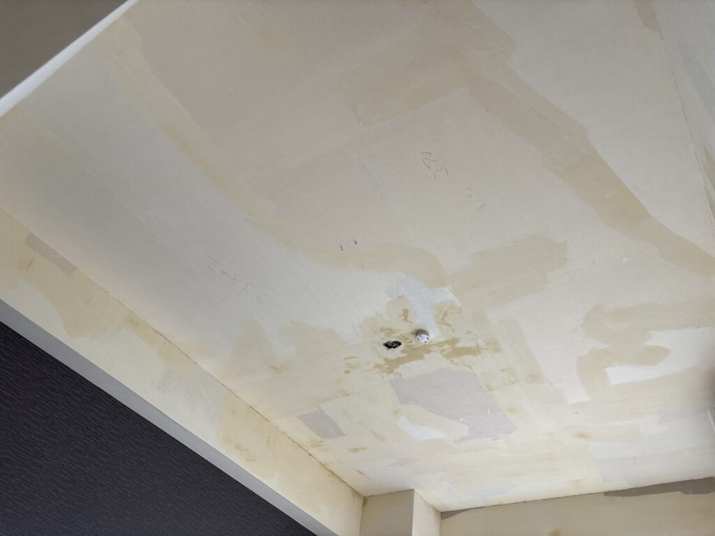 Wall with finishing joint compound applied before new wallpaper installation.
