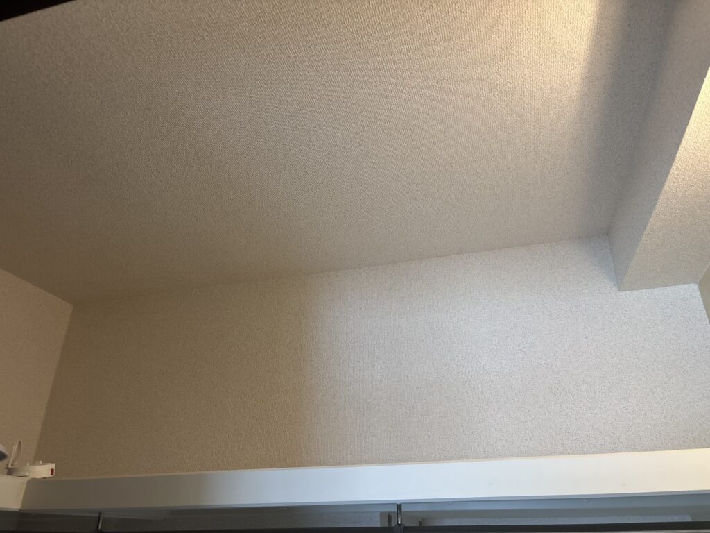 Finished wallpaper inside a renovated walk-in closet.