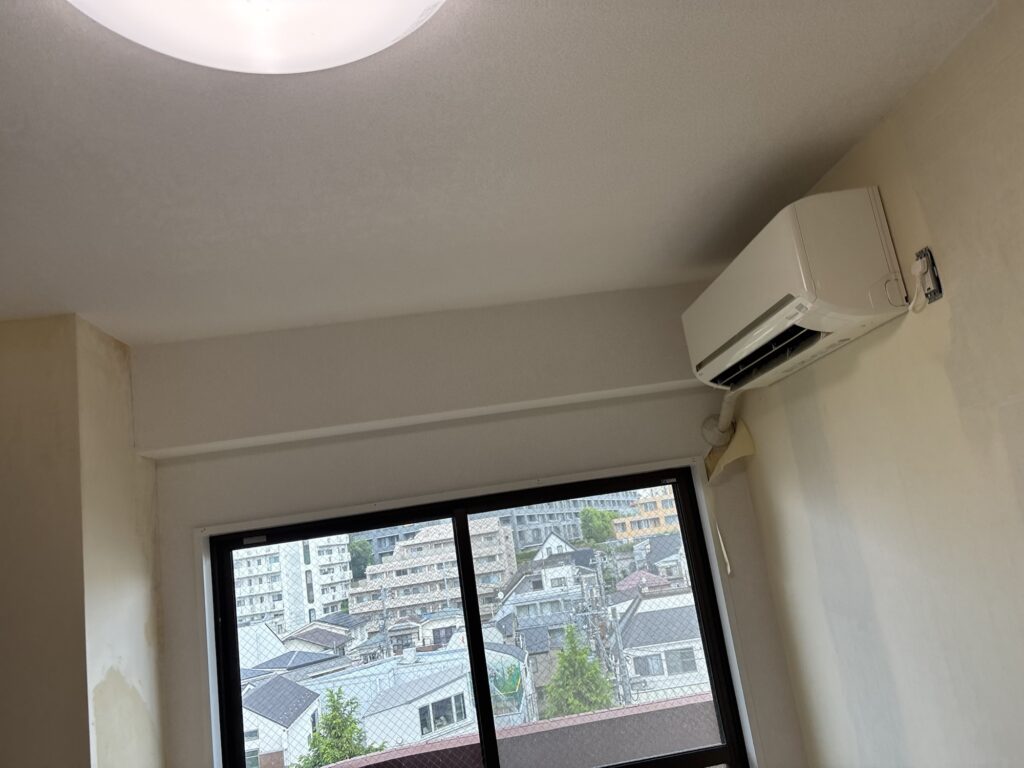 Completed wallpaper installation on the ceiling and beams of a condominium room.