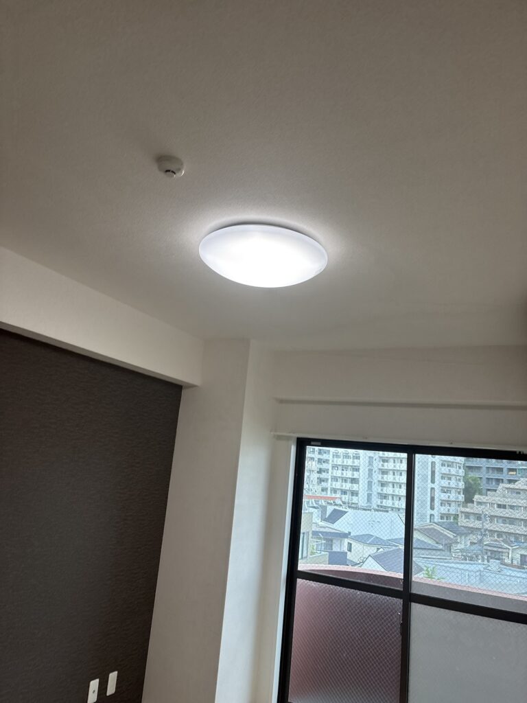 Completed condominium room after partial wallpaper replacement and paint touch-up.