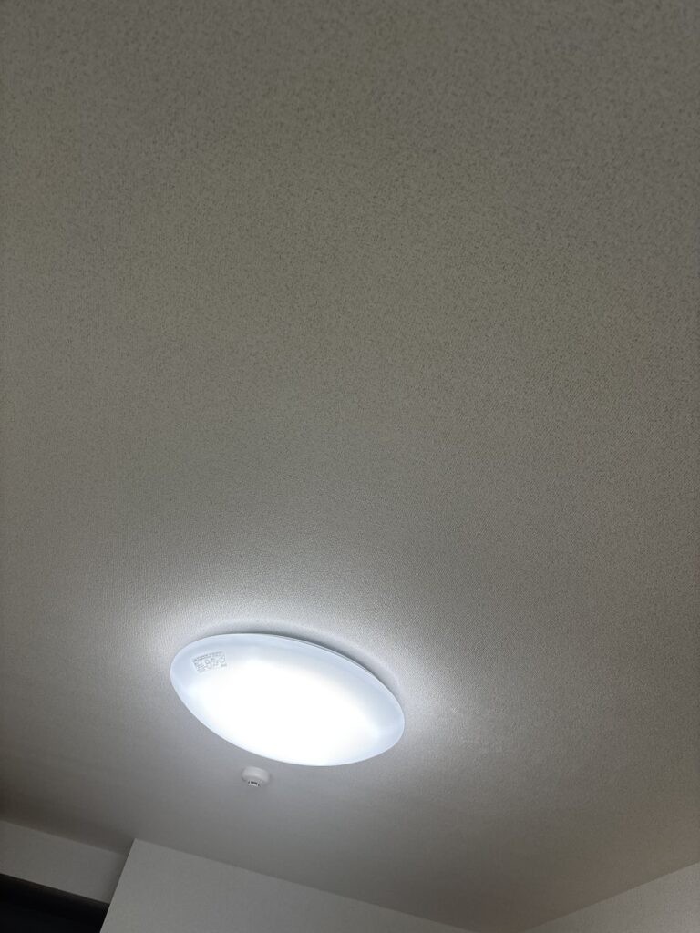 New wallpaper covering the repaired hole in the condominium ceiling.