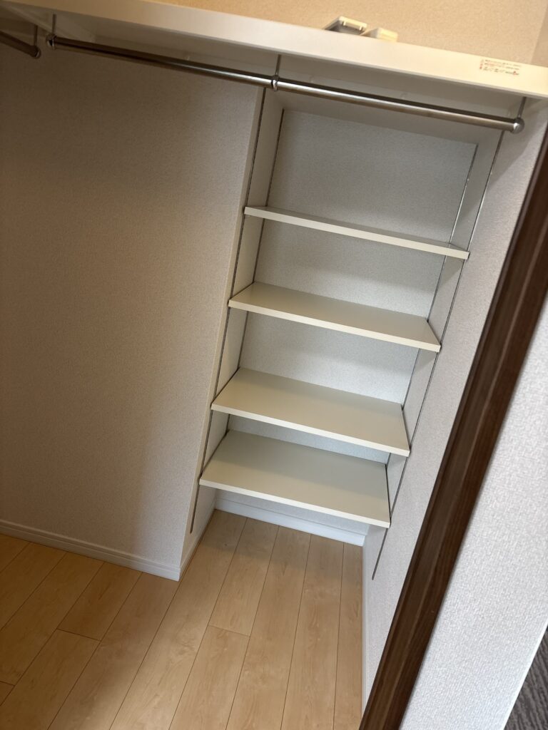 New wallpaper being installed inside a condominium walk-in closet.