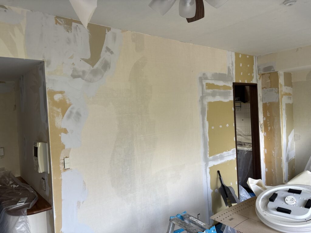 Base coat joint compound applied to plasterboard joints before wallpaper installation