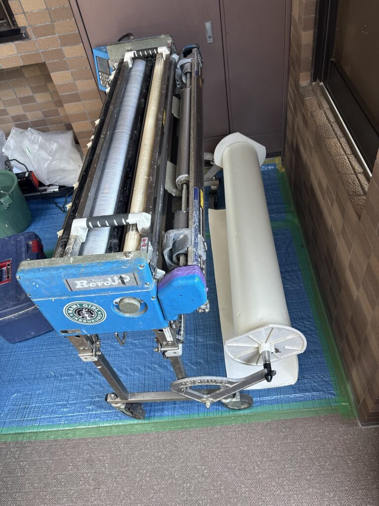 Wallpaper being prepared with a wallpaper pasting machine