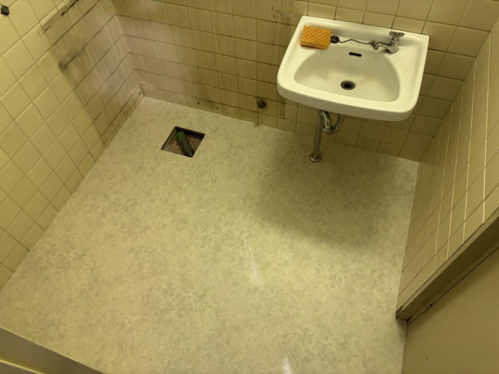 Completed cushion flooring installation in a condominium washroom