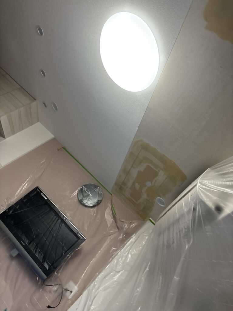 Finished joint compound preparation on a ceiling before wallpaper installation