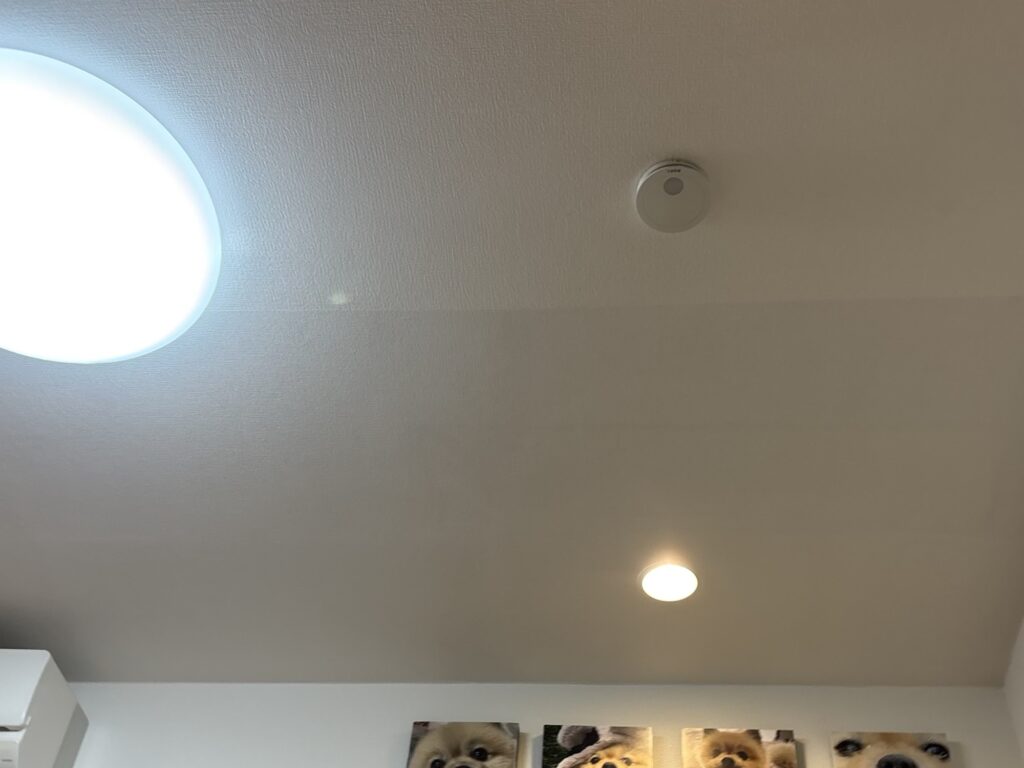 Completed partial ceiling wallpaper replacement in a Japanese apartment living room