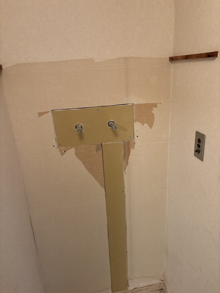 Washroom and laundry area before partial wallpaper and cushion flooring replacement in a Japanese apartment