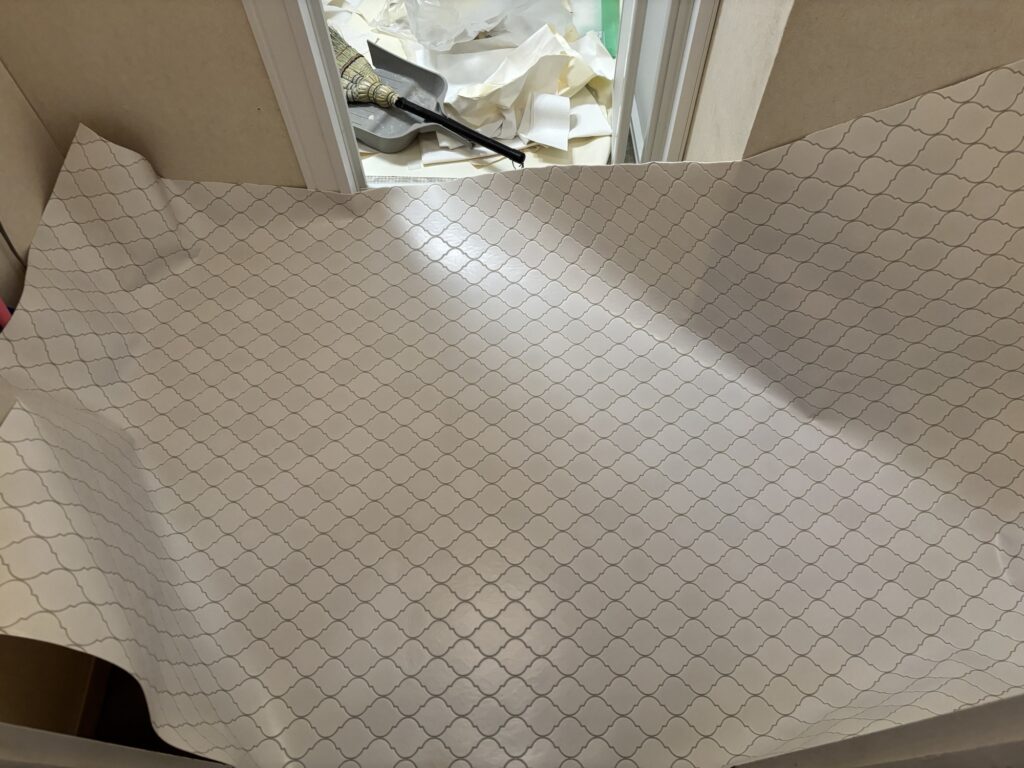Cushion flooring being installed in sections in a Japanese apartment washroom