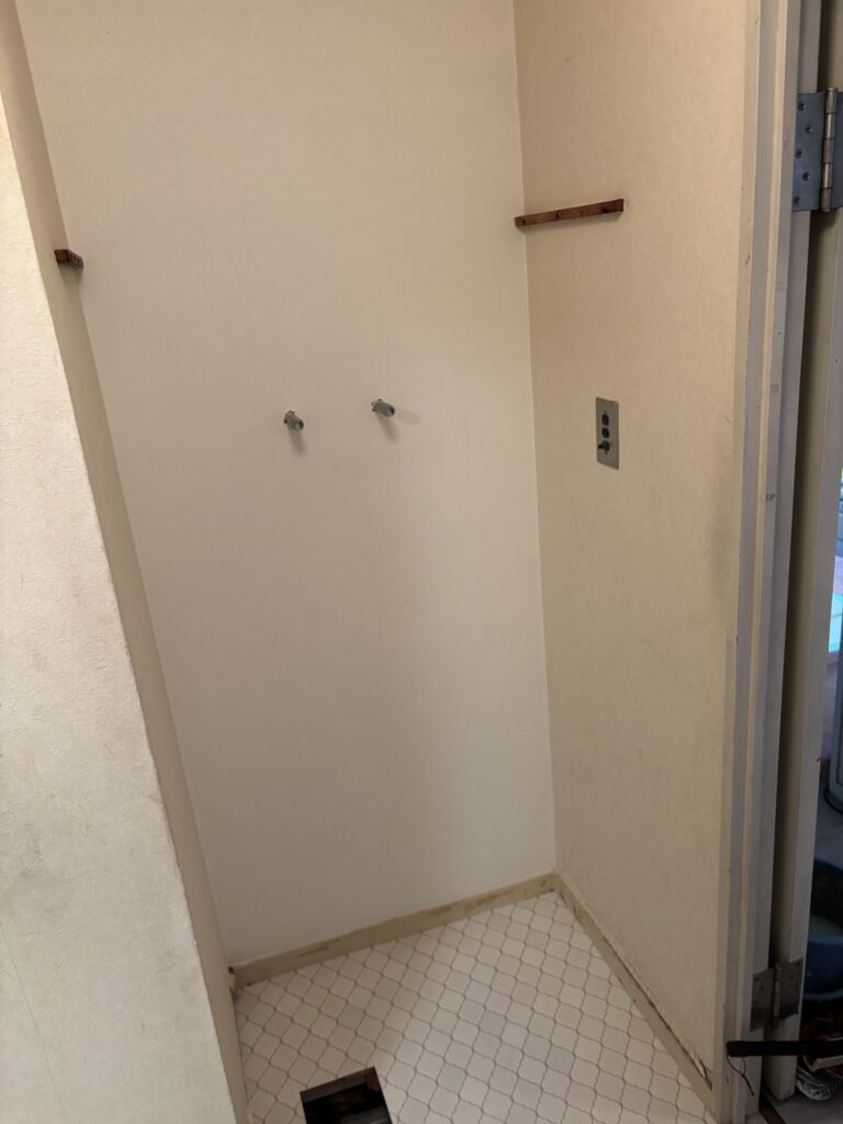 Completed washroom and laundry area after partial wallpaper and cushion flooring replacement