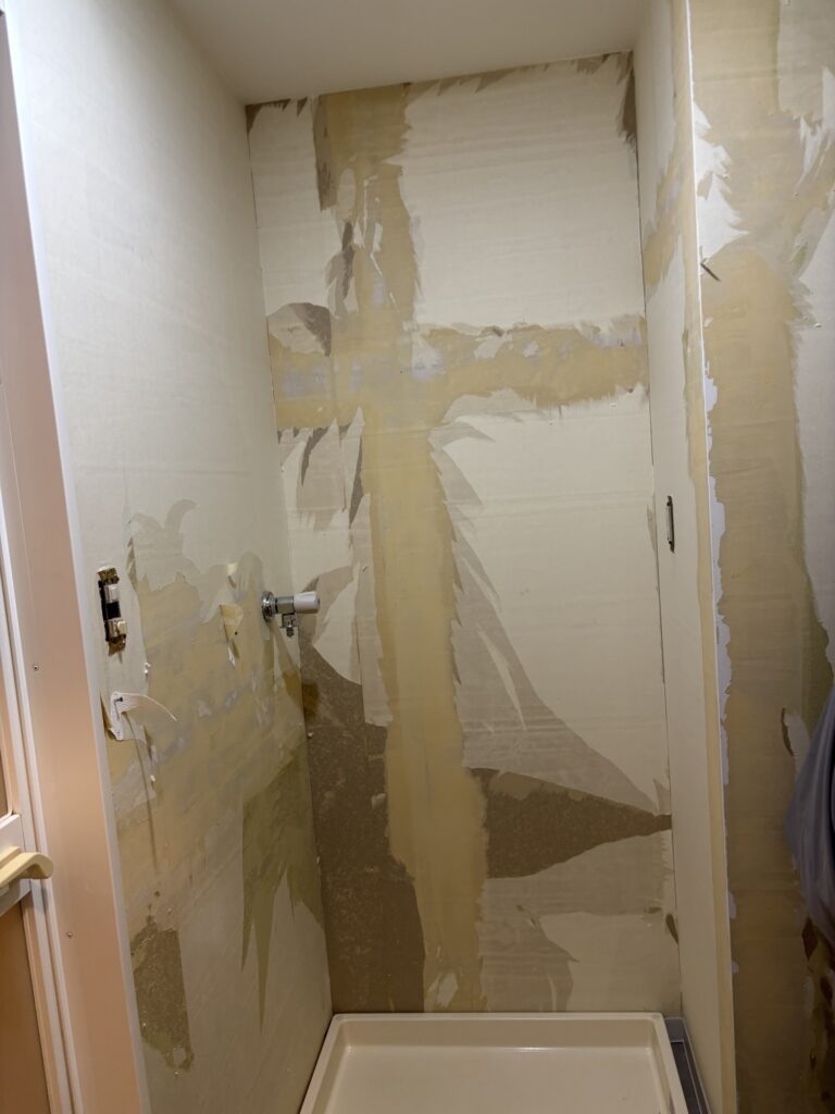 Washroom wall before wallpaper replacement showing the existing wall surface