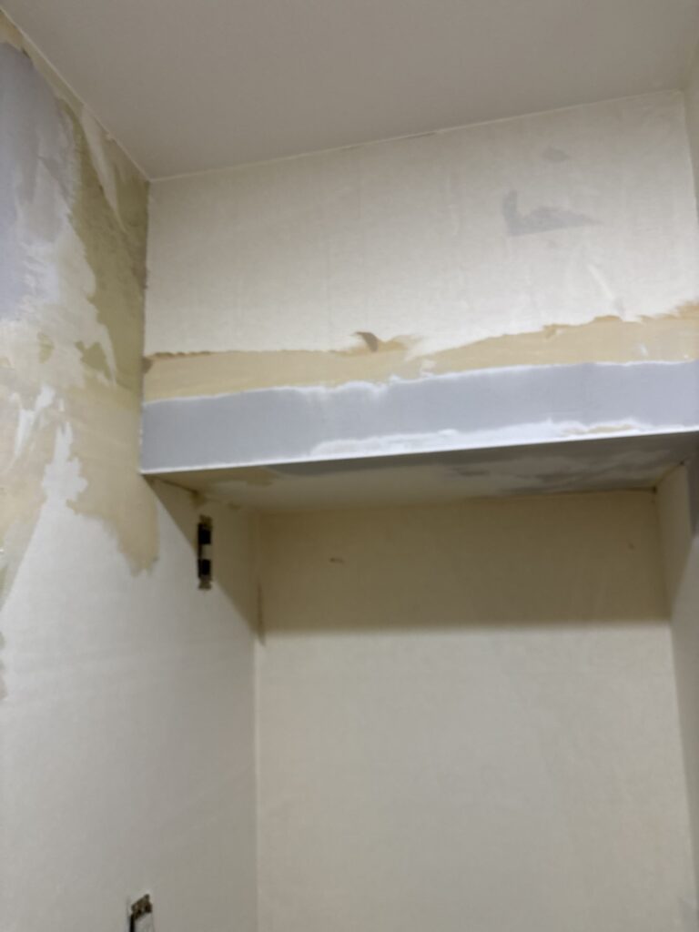 Washroom beam after base putty was applied to the wall surface