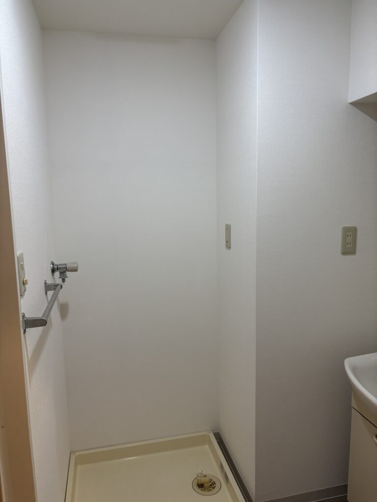 New white wallpaper installed around the washroom sink area