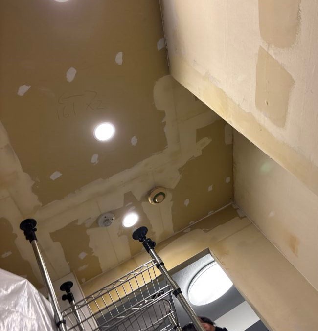 Kitchen ceiling with the finish coat of joint compound applied over the gypsum board joints, ready for sanding and wallpaper installation.