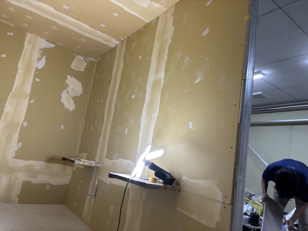 Gypsum board ceiling and wall surfaces after the finishing coat of joint compound has been applied.
