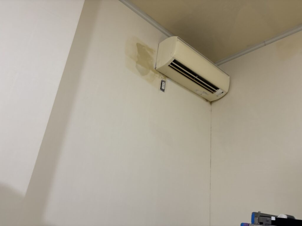 Finish putty completed around an air conditioner before wallpaper installation